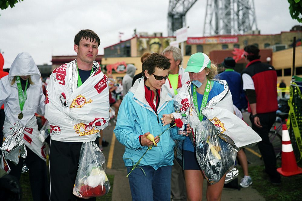 A Marathon Finisher Reaches For A Rose