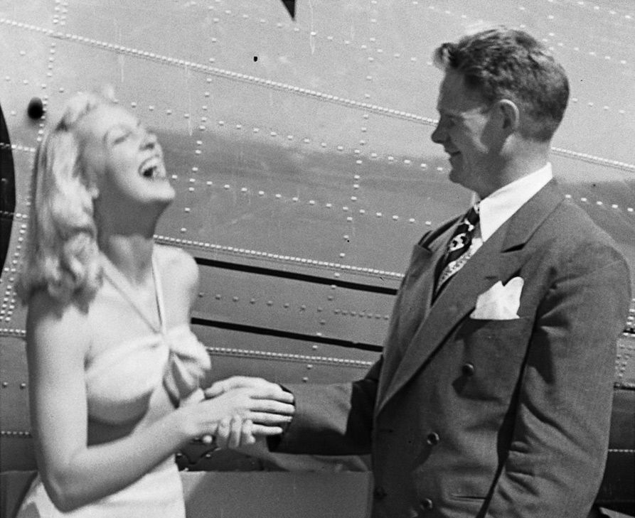 Bikini Girl shakes the man in the suit&amp;amp;#39;s hand