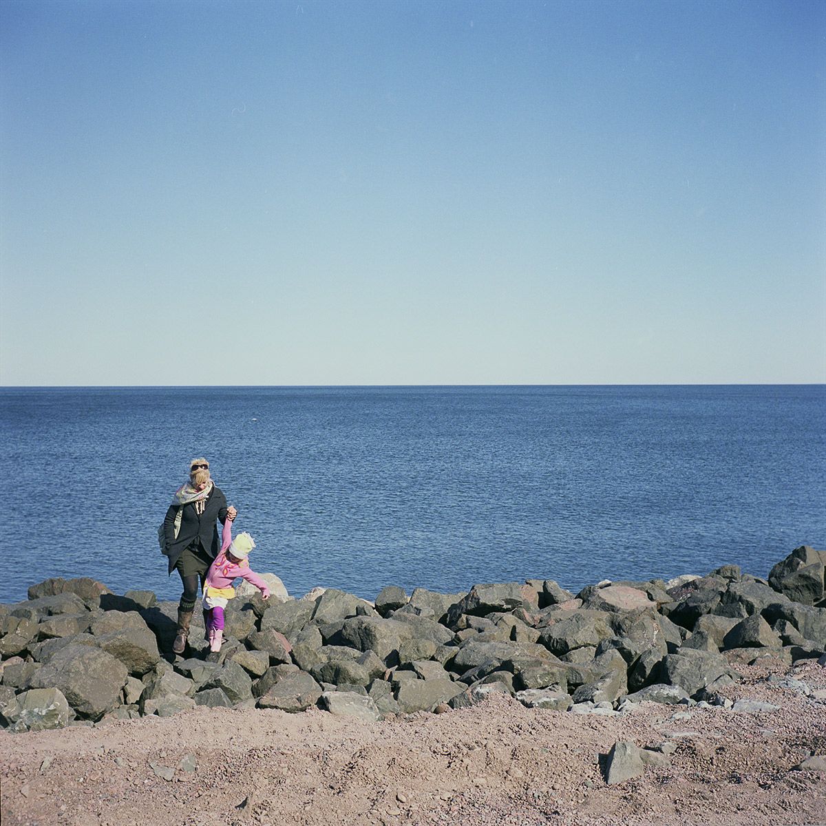 Helping a Child Over The Rocks, Duluth, Minnesota, March 2010